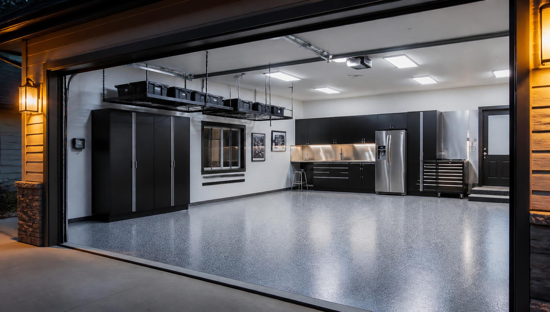 Finished garage with floor coating, cabinets, workbench, overhead storage and bright lighting